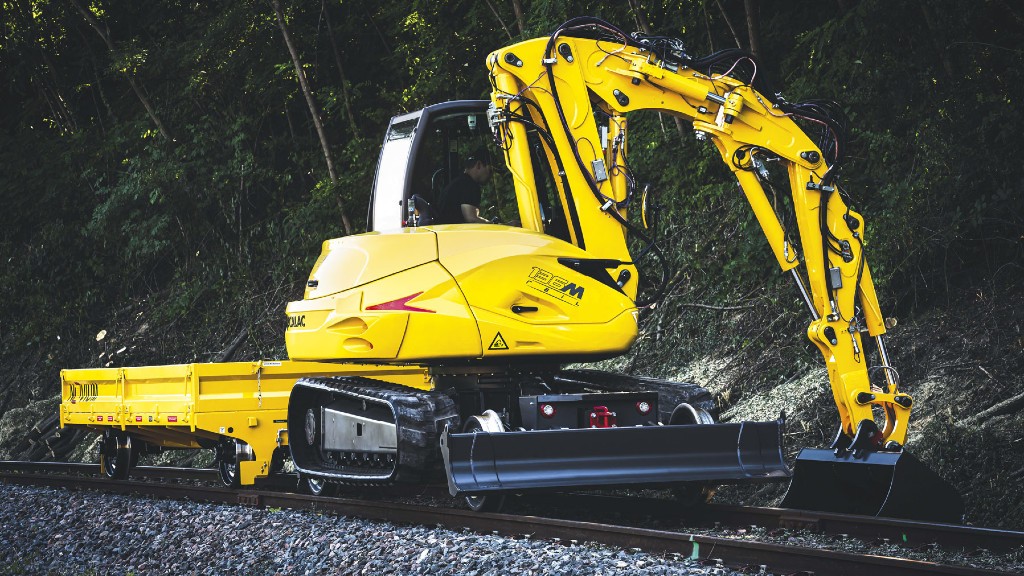 A 136MRail railroad excavator digging near railroad tracks