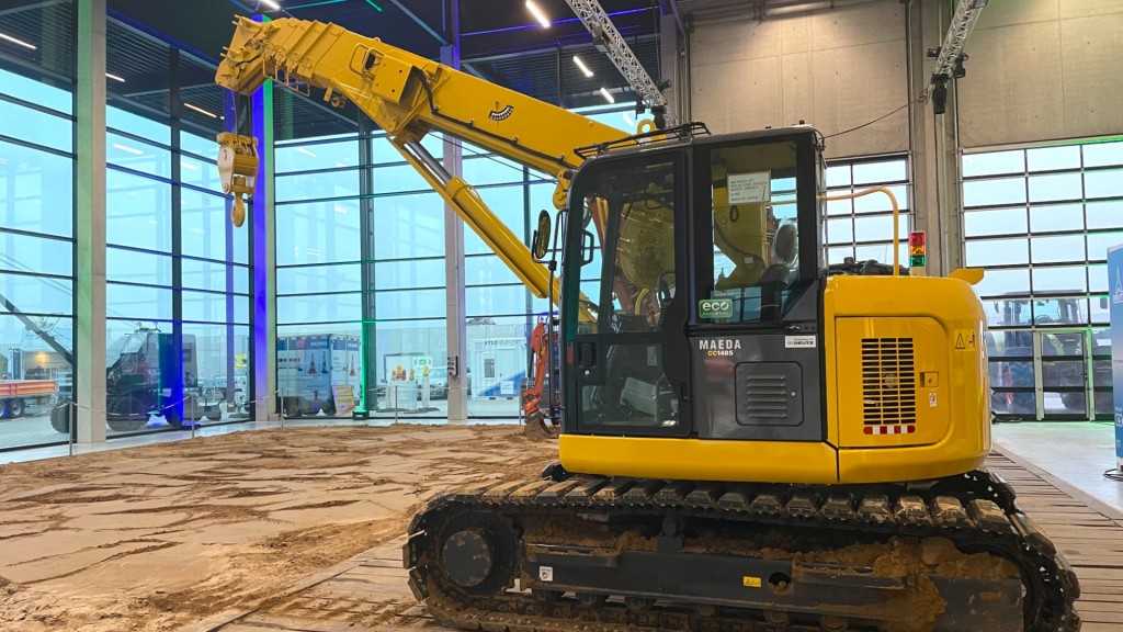 A DEUTZ and Maeda crawler crane at a trade show booth