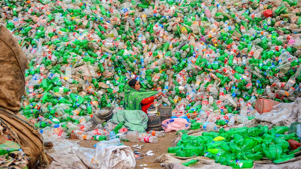 A pile of plastic pop bottles in a dump