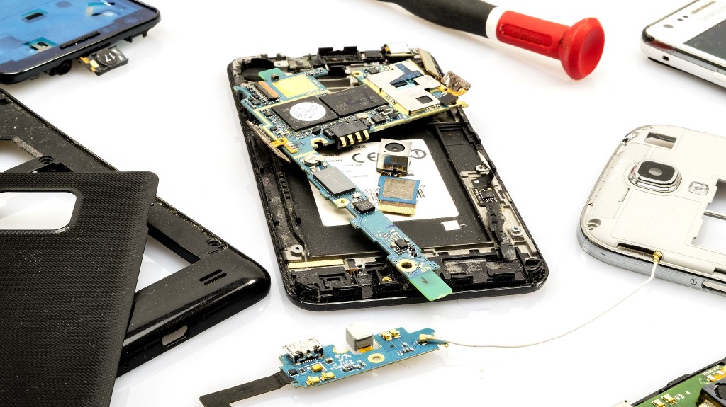 A deconstructed cell phone, showing the chip and board parts