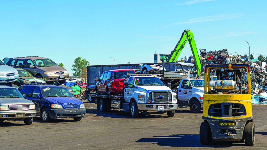 A pile of cars in a scrap yard