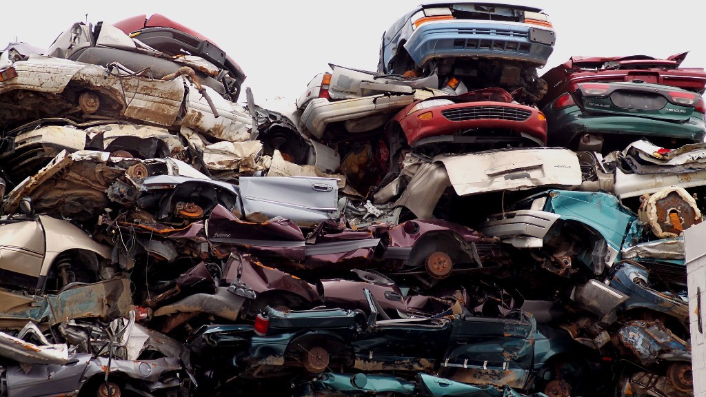 Destroyed cars stacked on top of each other in a scrap ayrd