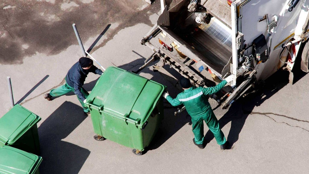 Collection workers about to lift waste into a collection truck