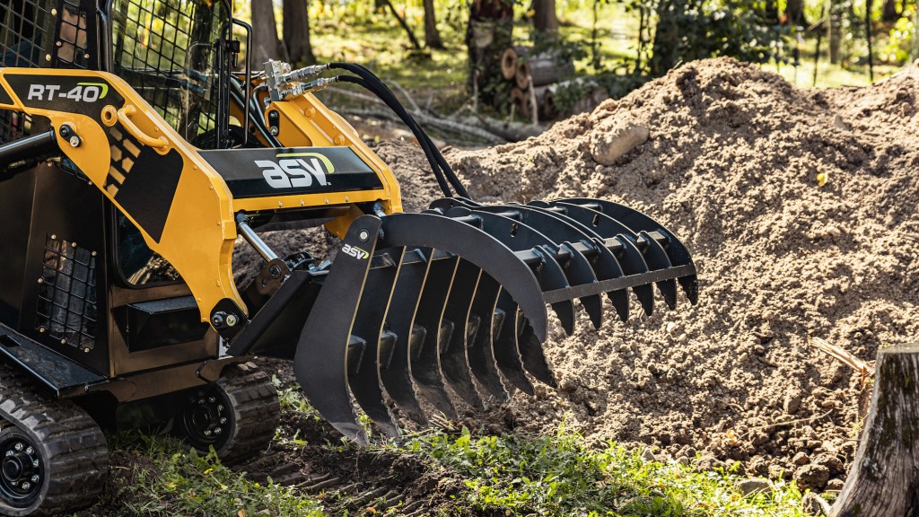 A grapple attachment attached to a compact track loader
