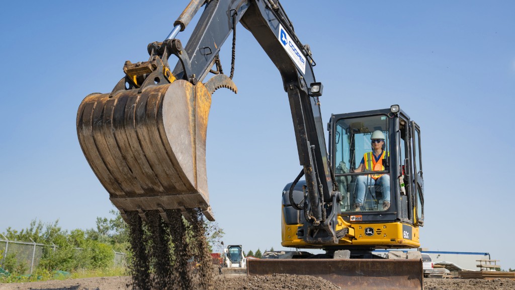 An excavator digs dirt on a job site