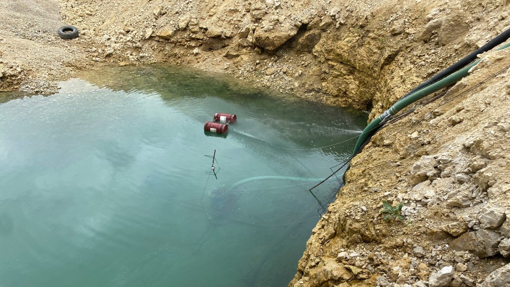 An electric pump submerged on a job site