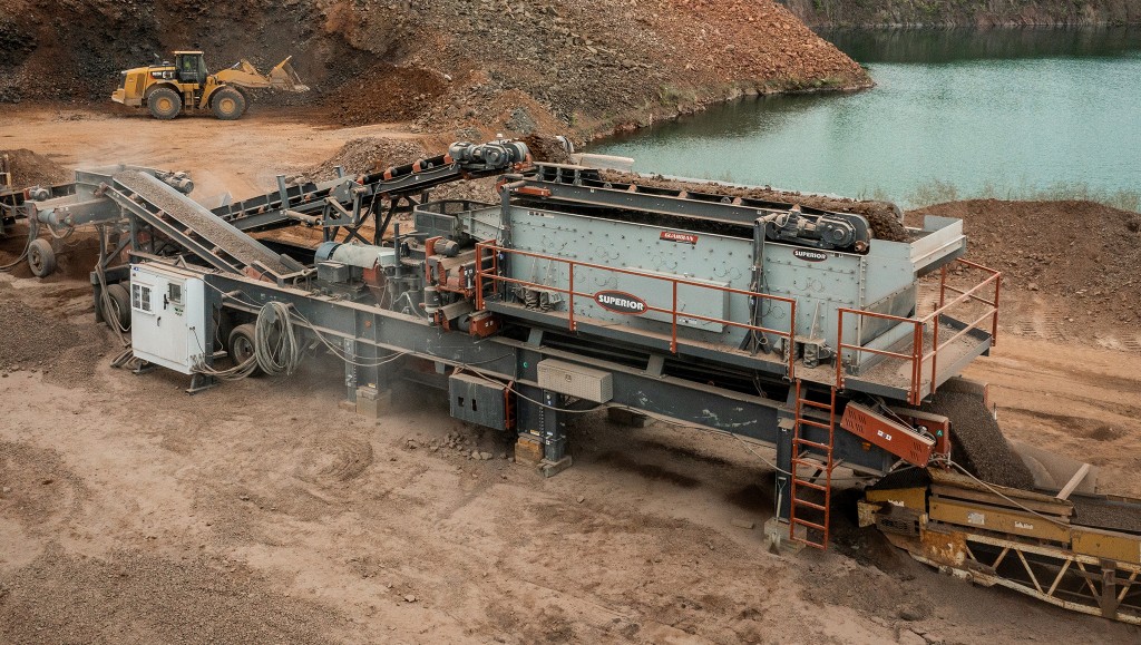 Superior Industries crushing plant near organics pile beside pond