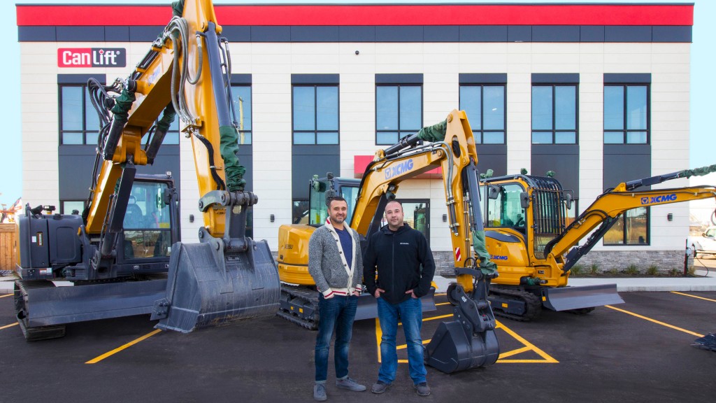 XCMG earthmoving equipment and two CanLift employees standing for a photo