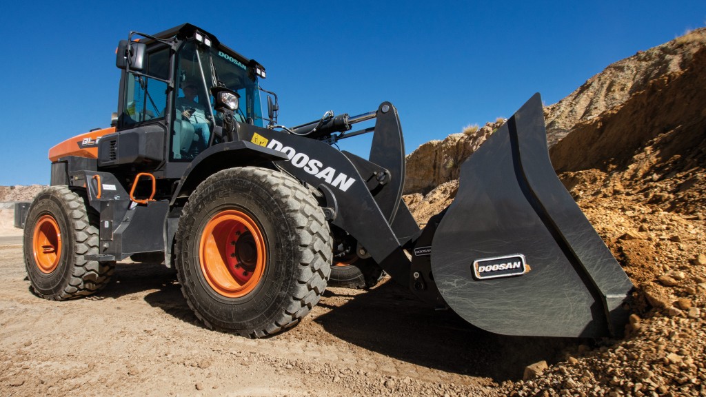 A wheel loader picking up dirt on the job site