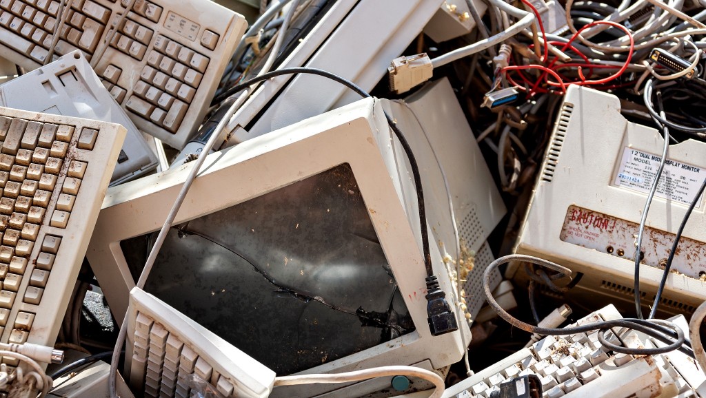 Old and degraded computers lay in a pile