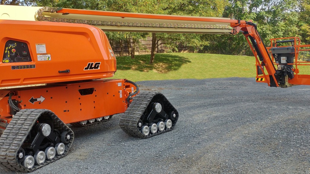 A JLG boom lift parked on a gravel road