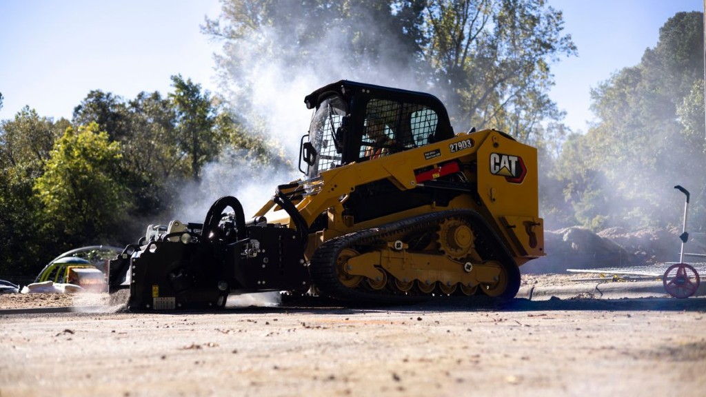 A compact track loader working on a job site