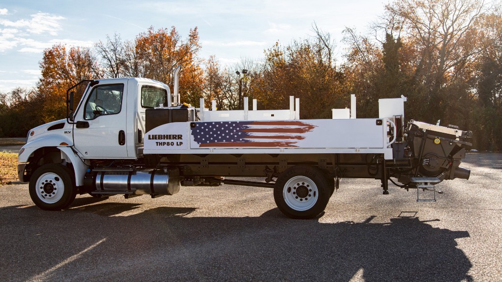 A truck mounted concrete pump parked in a parking lot