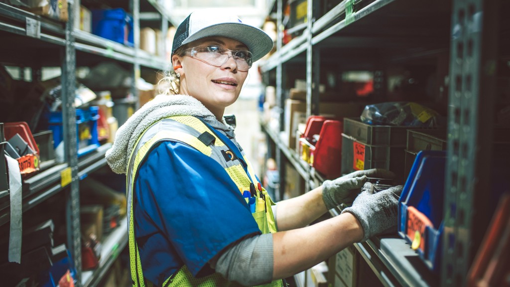 A worker grabs replacement parts from the shelf