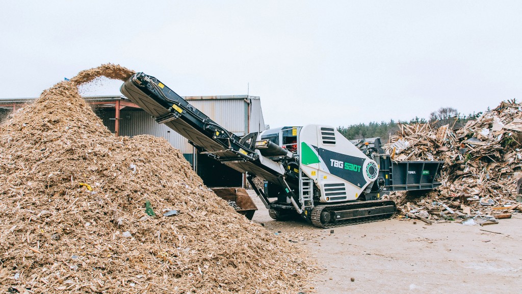 A shredder shreds wood waste on the job site