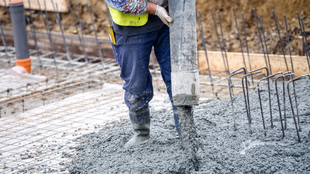 A wroker pours concrete on the job site