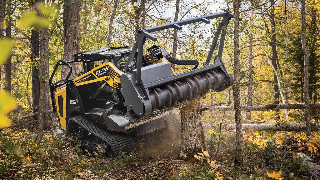 ASV forestry compact track loader mulching a tree in the woods