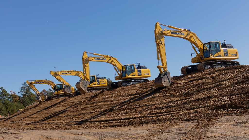 Komatsu excavators parked at the top of a dirt hill