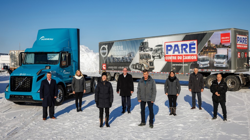 An electric truck parked in a snowy parking lot