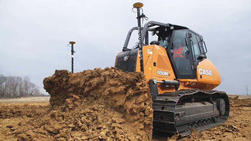 A CASE bulldozer pushing a large mound of dirt