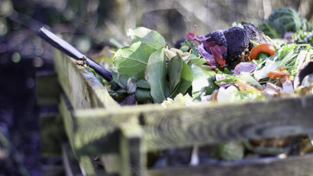 Organic waste is composting inside a wooden bin