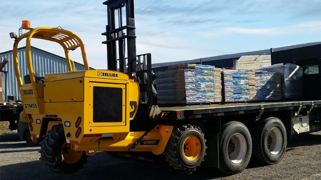 A truck mounted forklift parked at a job site