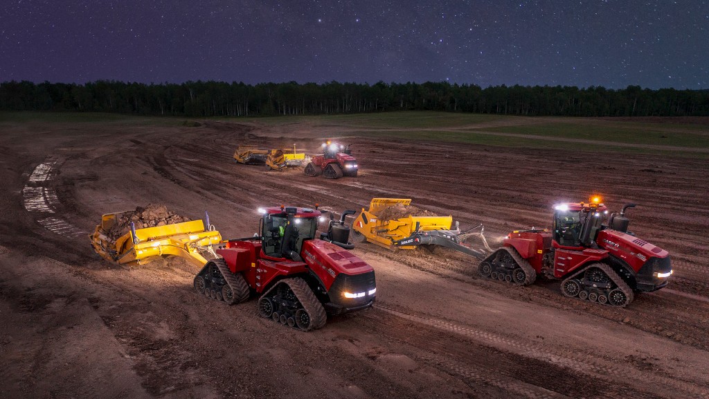 Scrapers work on a dirt field