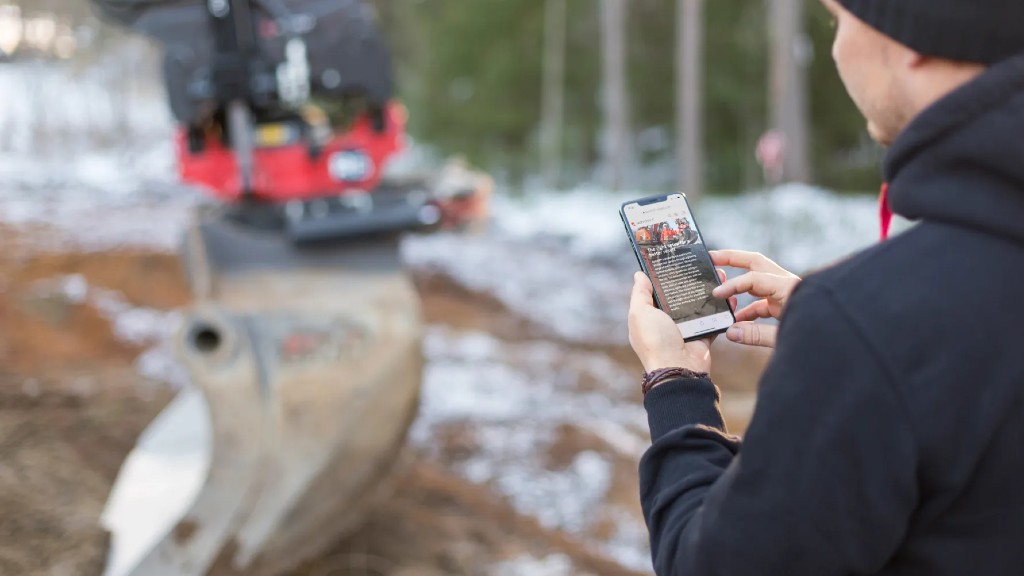 A worker uses a smartphone on the job site