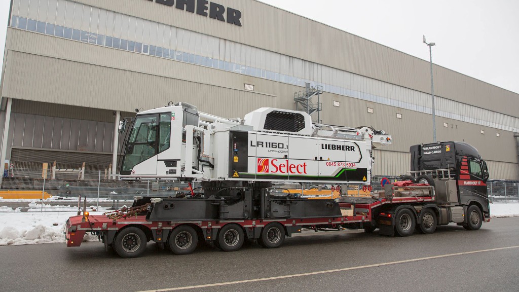 A crawler crane leaving a manufacturing facility