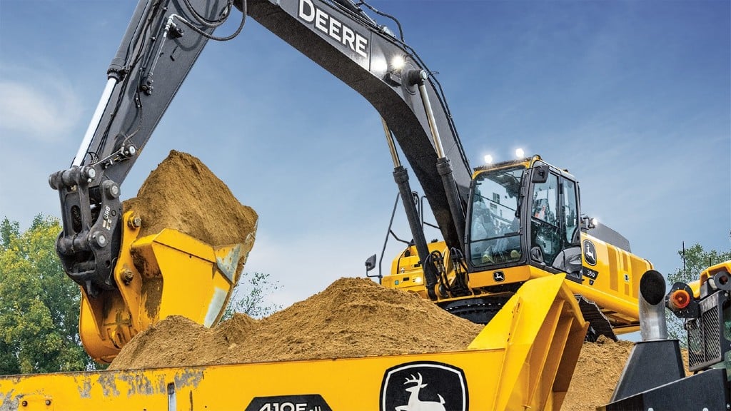 A John Deere excavator loading a truck