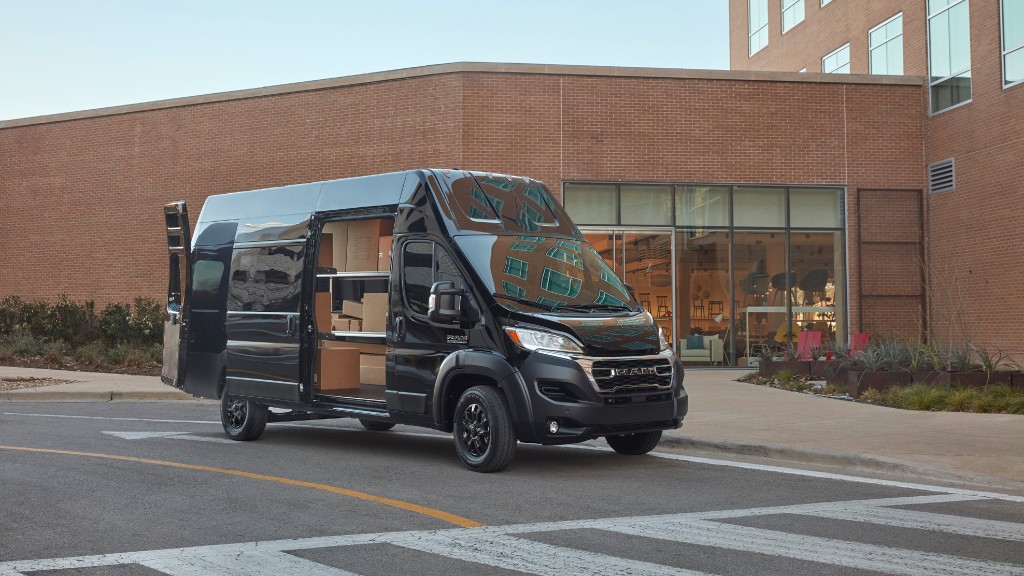 A van full of packages is parked at a building