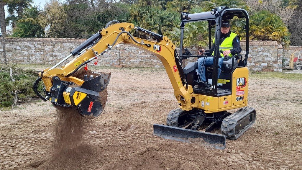 An excavator grabs dirt on a job site