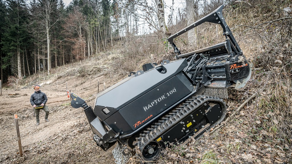 A remote-controlled carrier vehicle moves up an incline