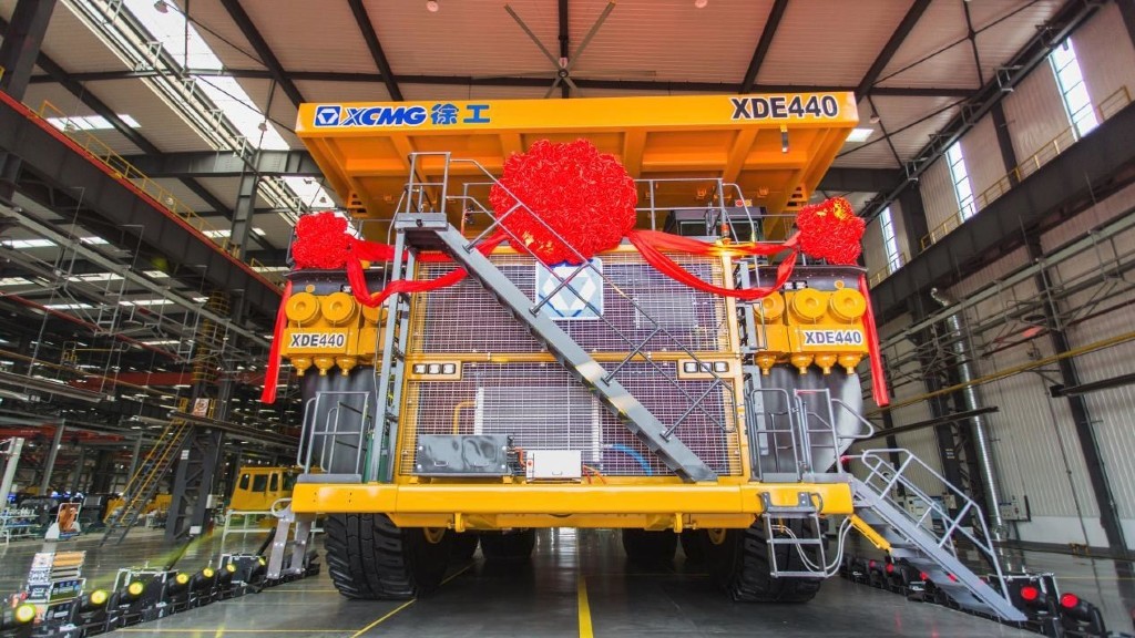 A mining truck is parked in a manufacturing facility