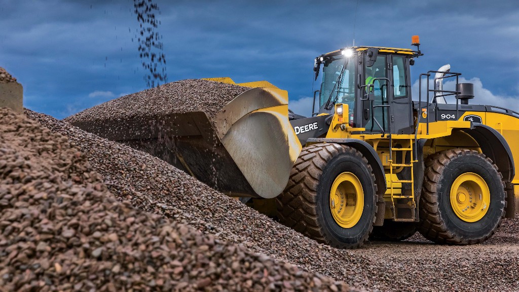 A wheel loader picks up material on a job site