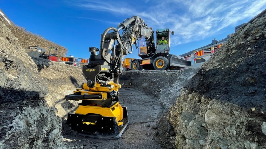 A compactor plate attachment compacts ground on a job site