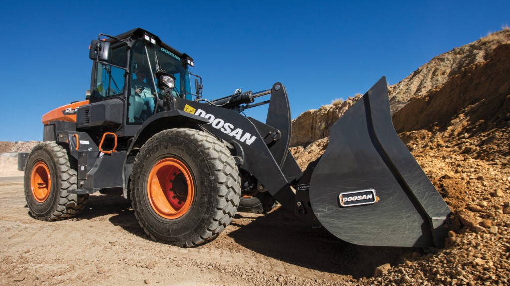 A wheel loader picks up dirt on a job site