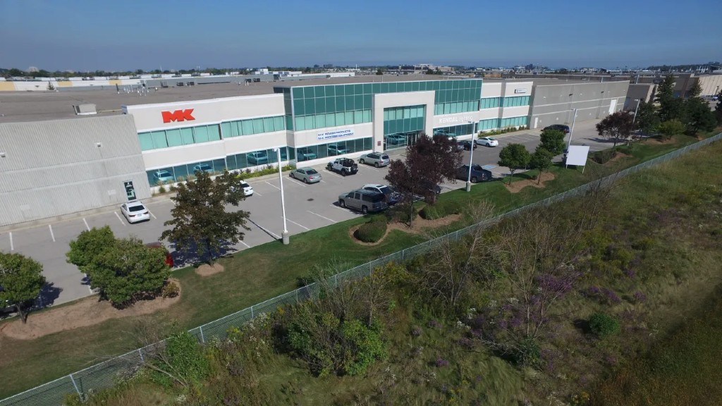 An office building with cars in the parking lot