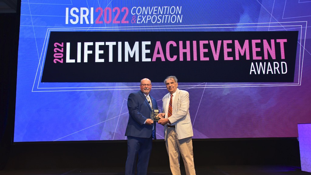 An award is handed out on a large stage