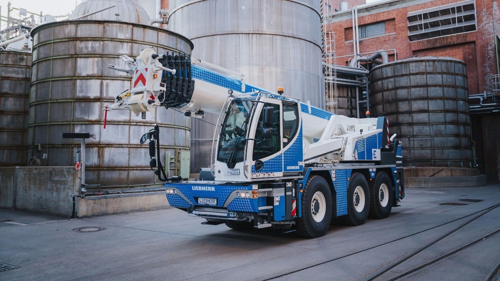 A mobile crane is parked in an industrial job site