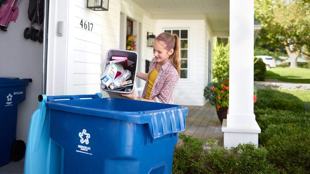 Somebody puts plastic recyclables into a curbside bin