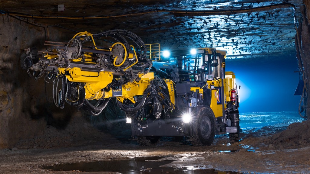 An piece of underground mining equipment lights a tunnel