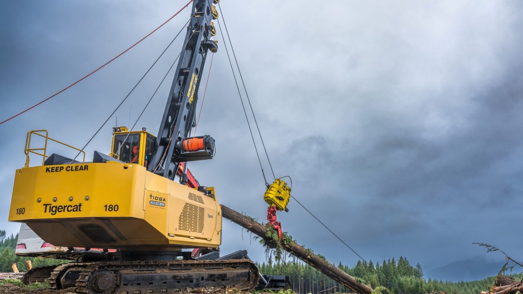 A swing yarder moves a log on a job site