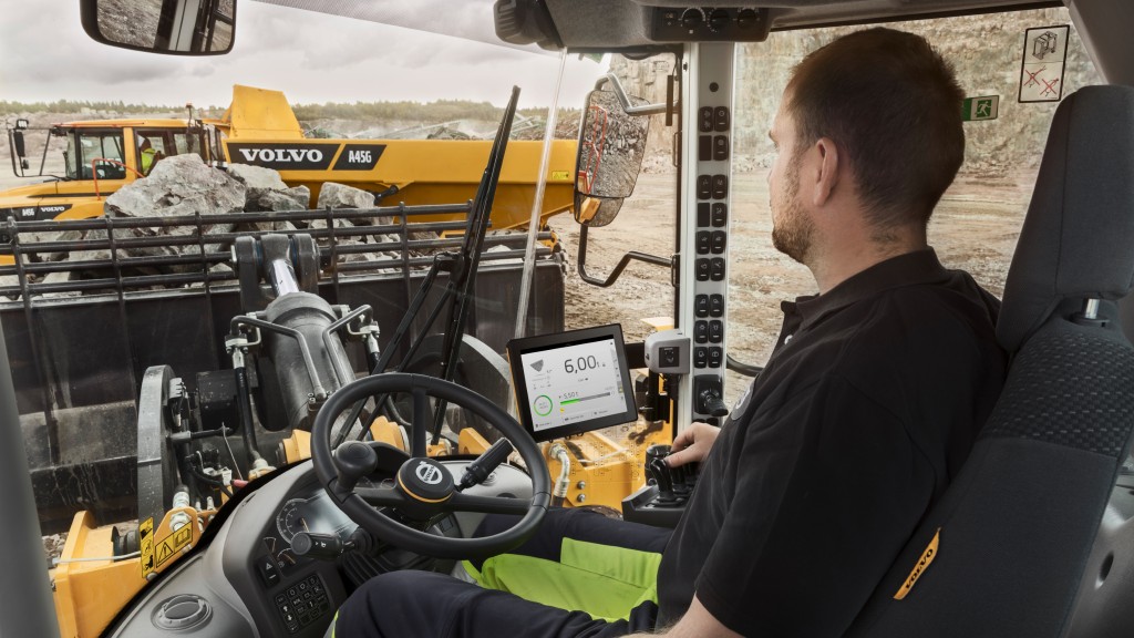 An operator operates a wheel loader on a job site