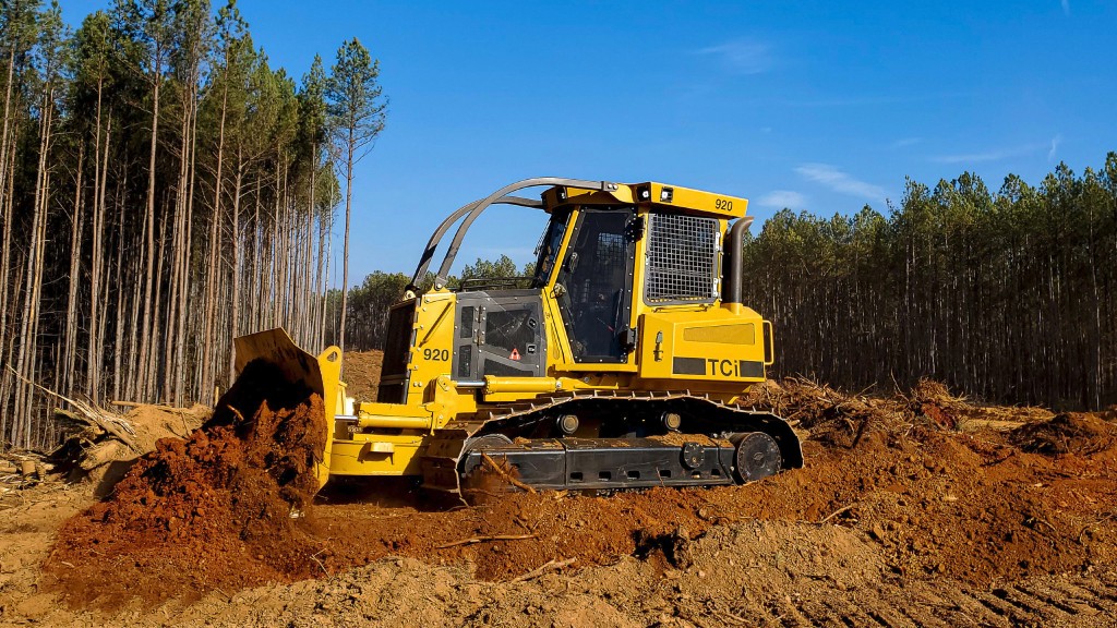 A forestry dozer pushes dirt on a job site