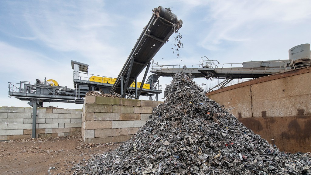 Steel scrap falls off a conveyor into a pile
