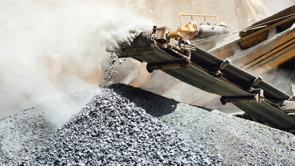 Crushed aggregates falls off a crushing machine conveyor