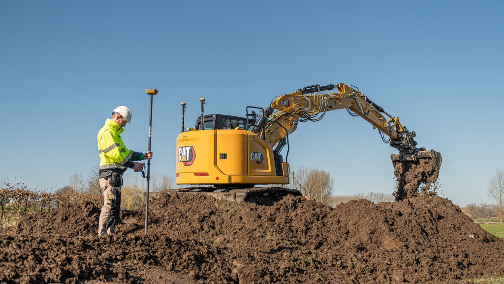 An excavator digs dirt on a job site