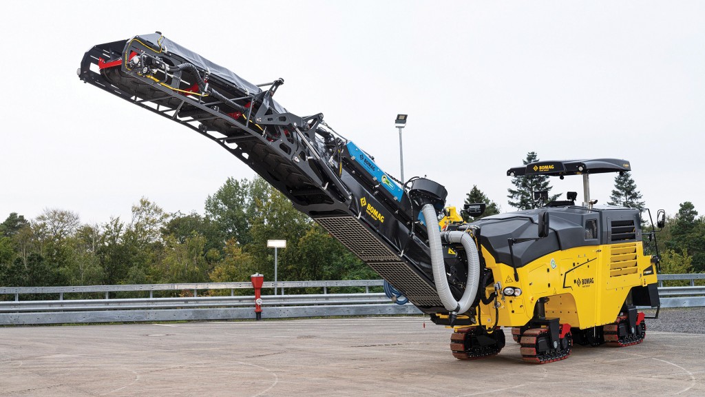 A milling machine is parked in a parking lot