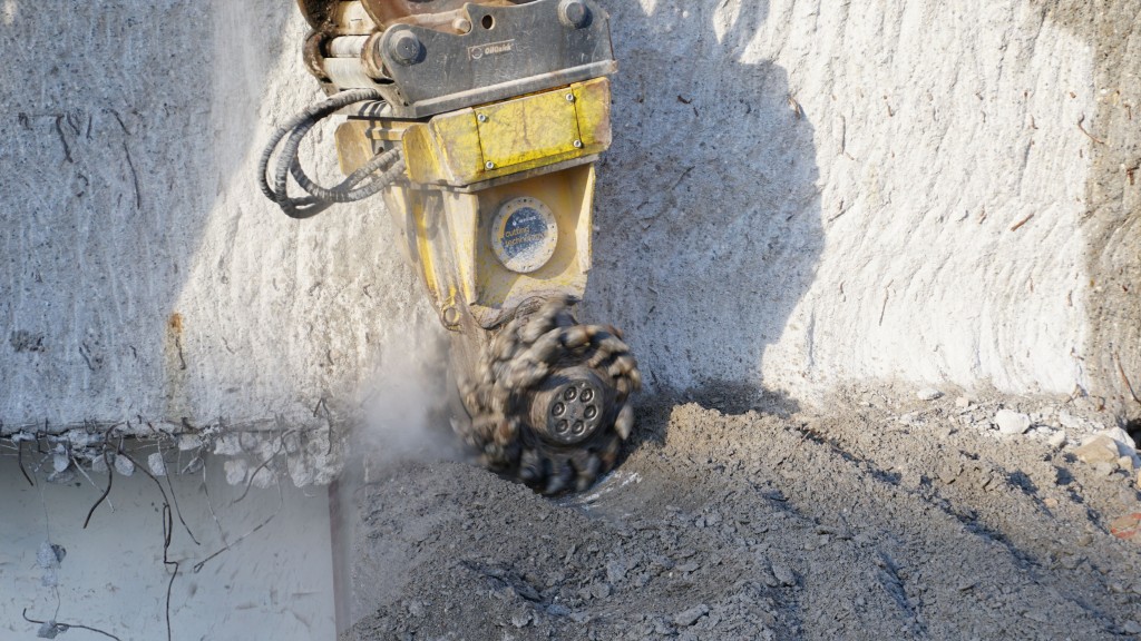 A drum cutter cuts through rock